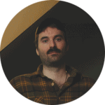 Colorful dodgems ride with cars bouncing in an arcade setting.