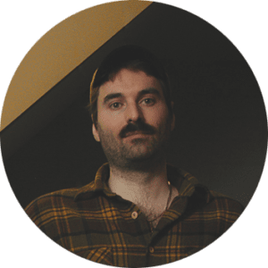 Colorful dodgems ride with cars bouncing in an arcade setting.